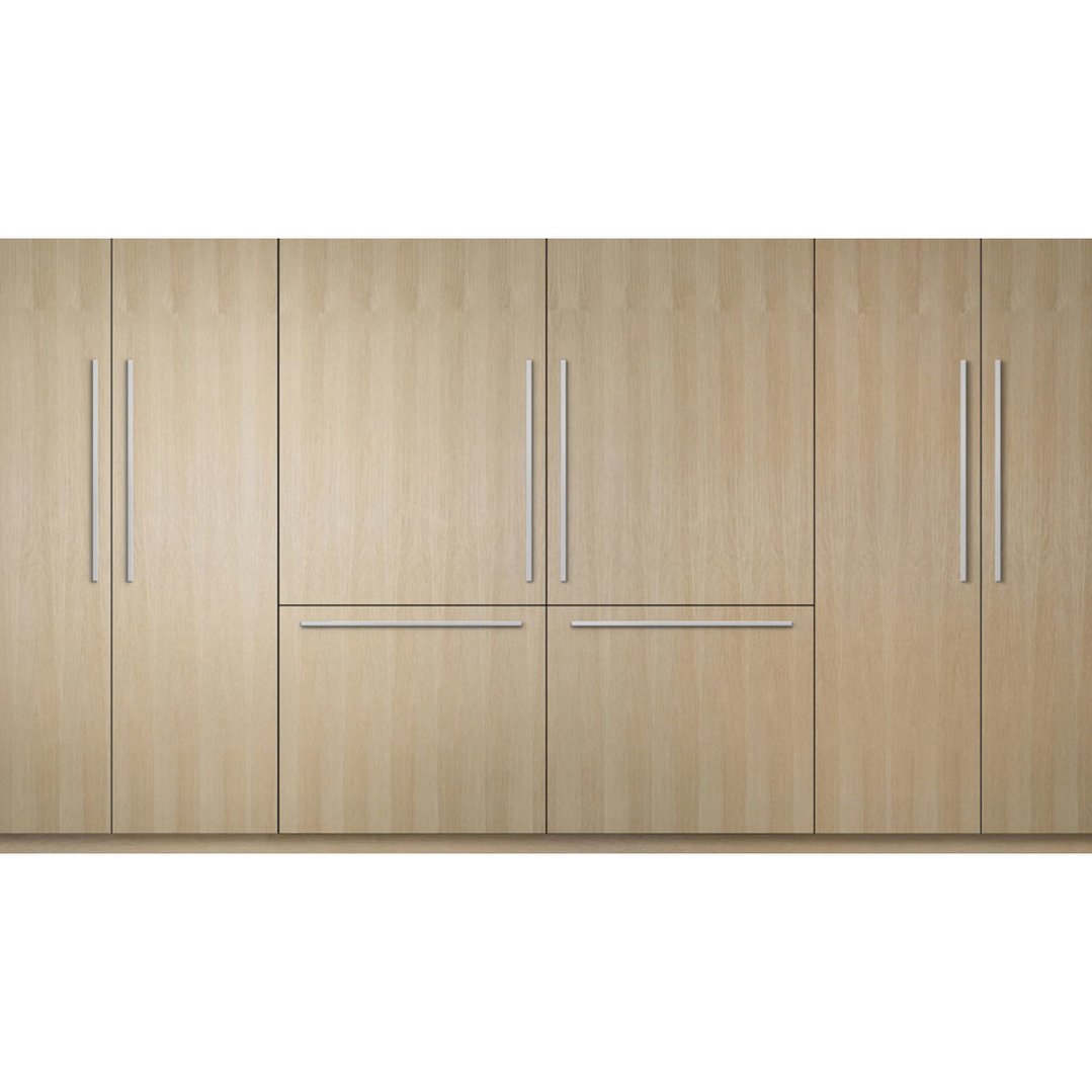 Integrated refrigerator freezer with light wood paneling and stainless steel handles
