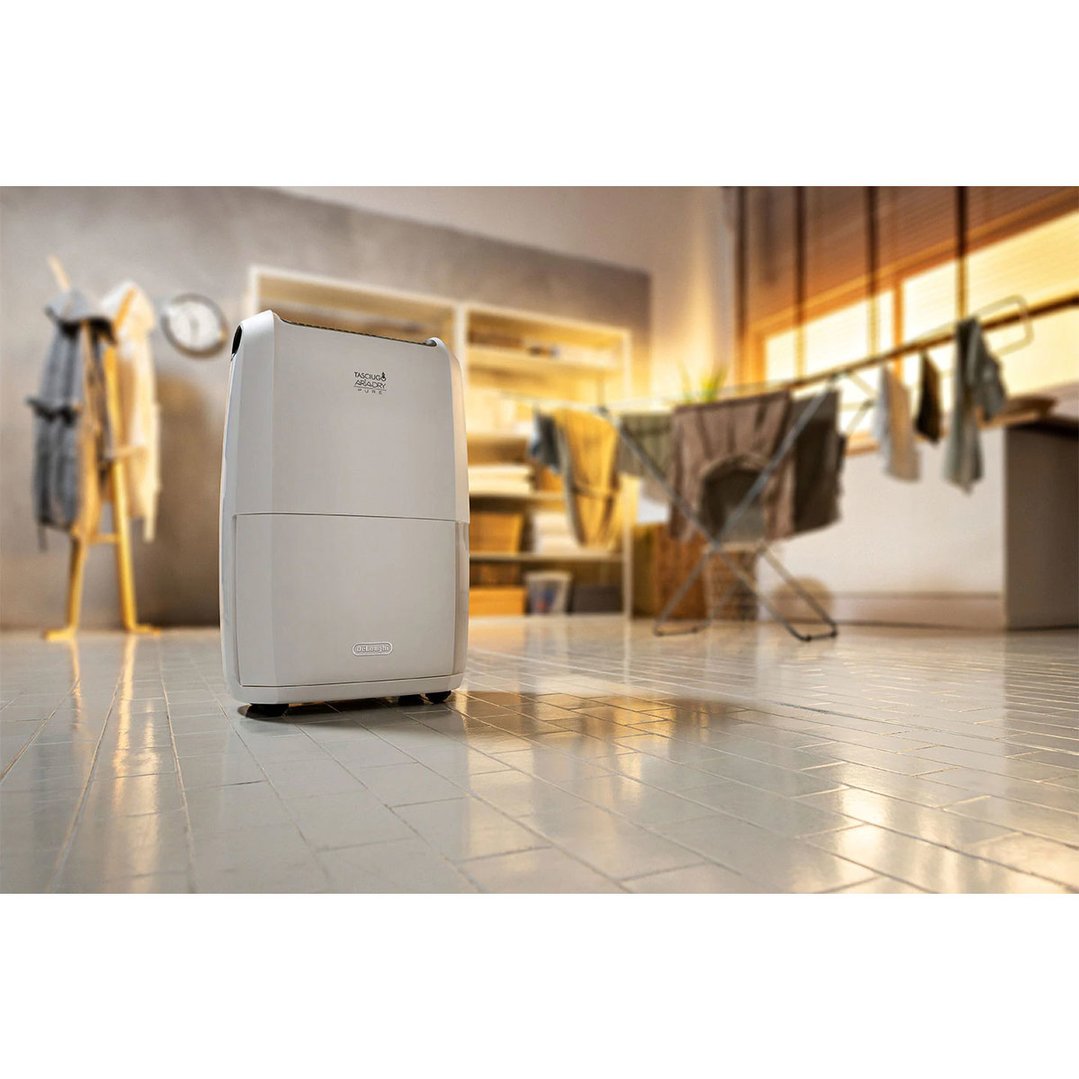 Dehumidifier in a laundry room with clothes drying in the background