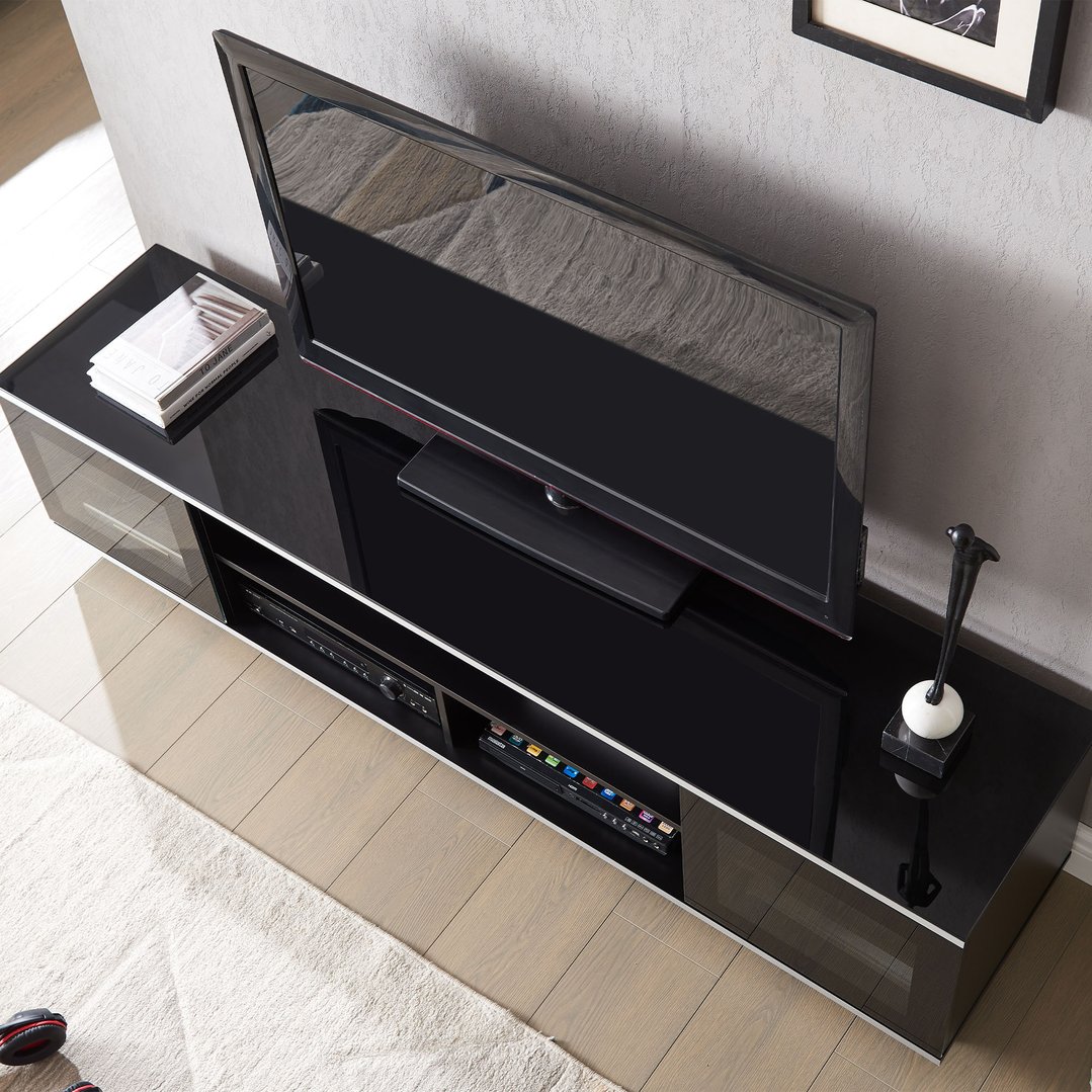 Black TV cabinet with a TV and media players in a living room
