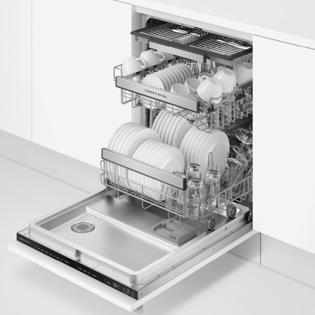 Open integrated dishwasher filled with white dishes and glasses in a kitchen