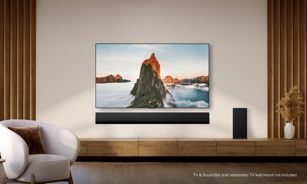 A large TV and soundbar mounted on a wall in a modern living room