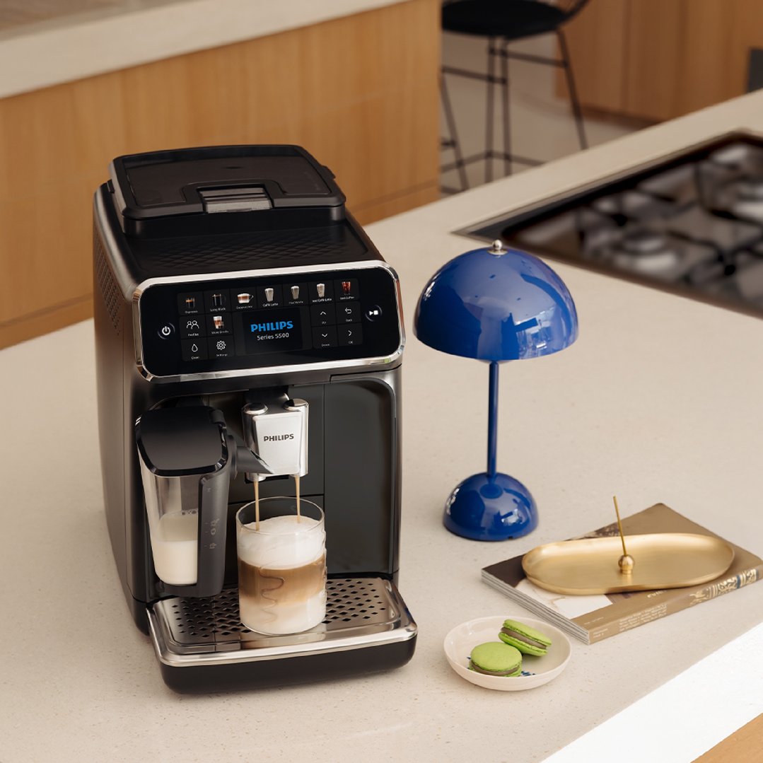Philips Series 5500 Fully Automatic Espresso Machine making a latte in a kitchen