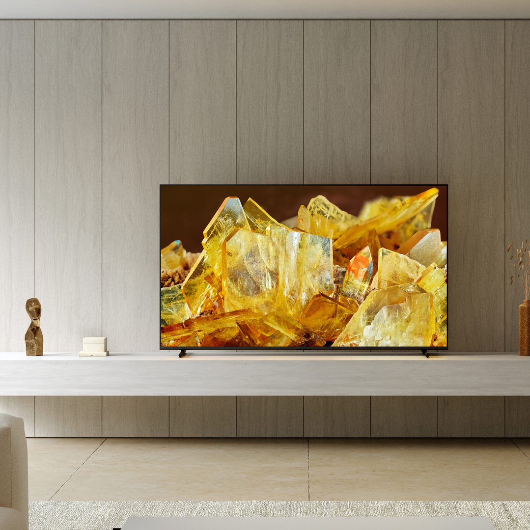 A SONY 55 inch TV displaying yellow crystals in a modern living room