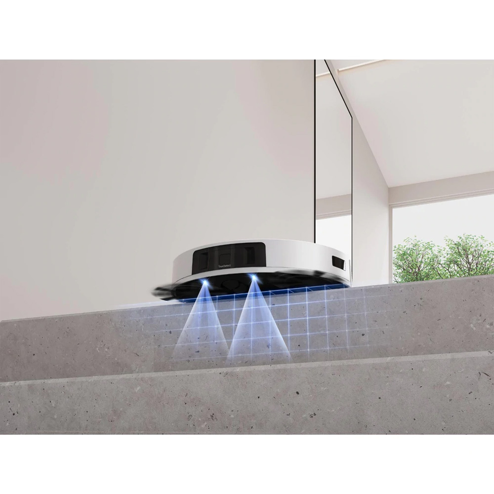 A robotic vacuum on a concrete surface with blue light beams scanning the floor