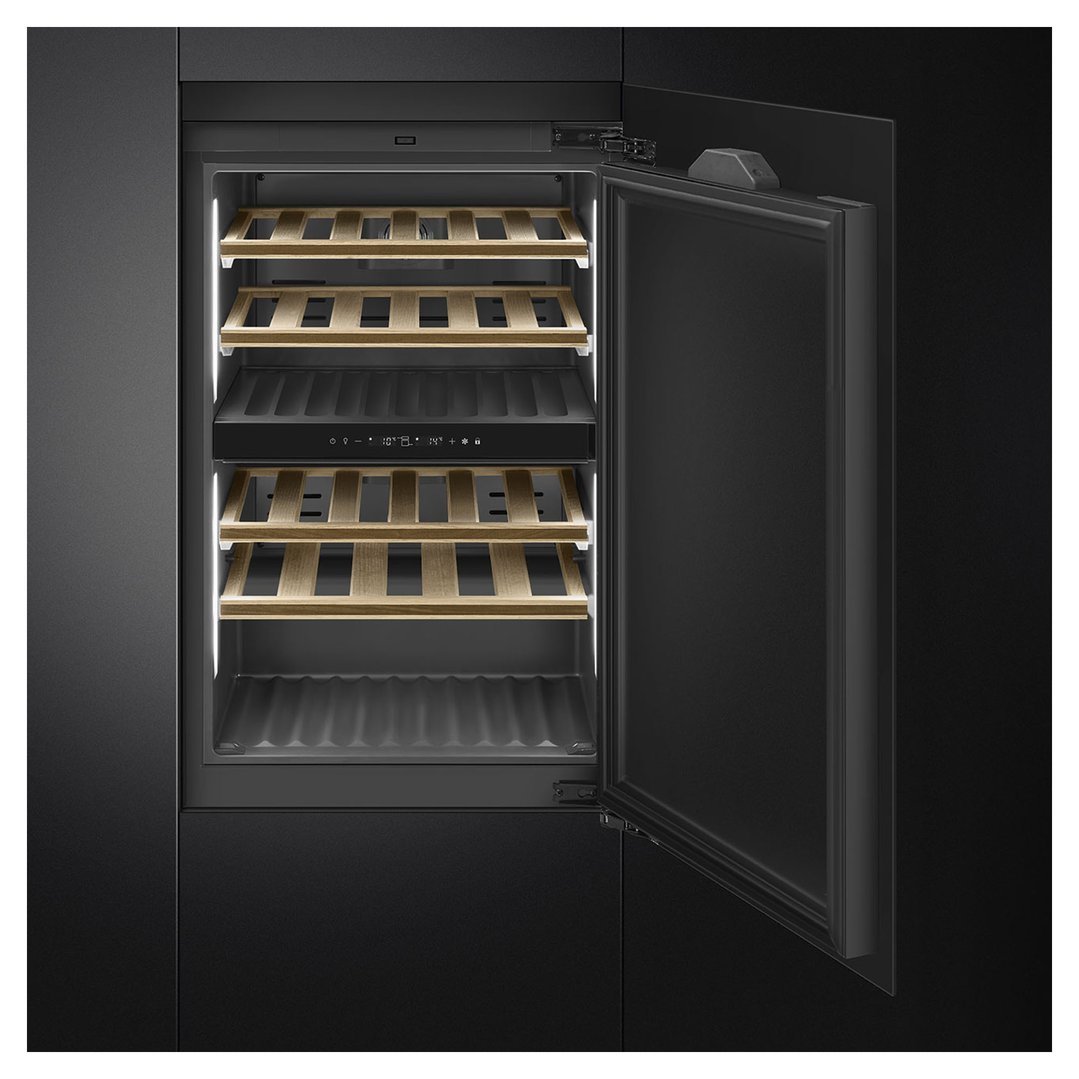 Open built-in wine cooler with wooden shelves in a dark kitchen setting