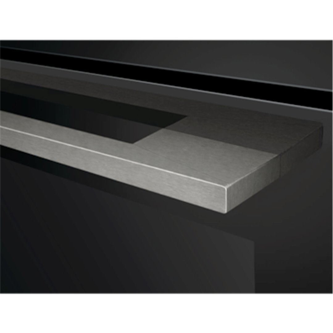 Close up of the handle of a black built-in oven