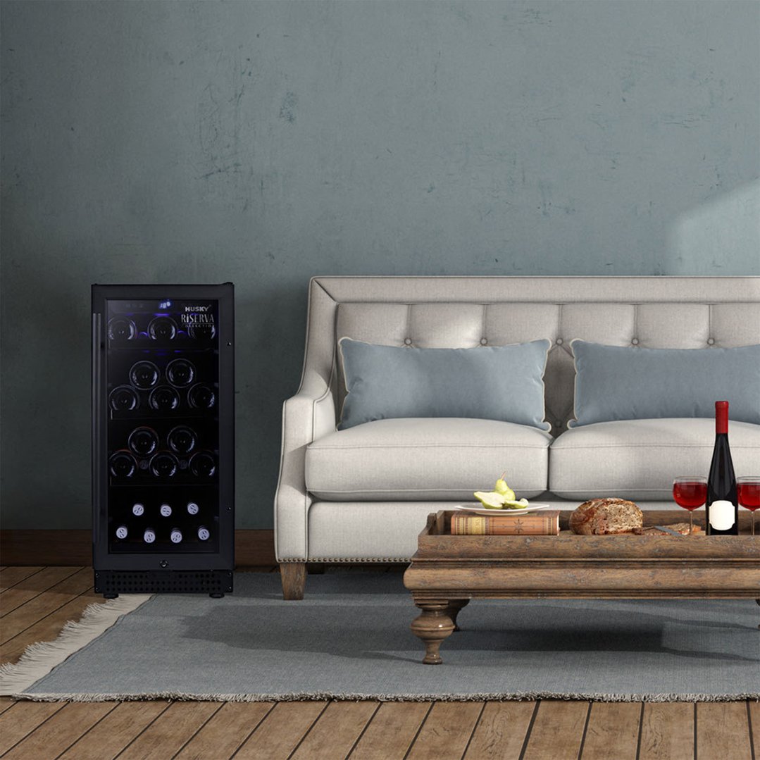 Black wine fridge in a living room next to a sofa and coffee table