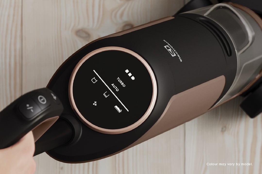 Hand holding an Electrolux UltimateHome 700 Wet & Dry Vacuum on a wooden floor