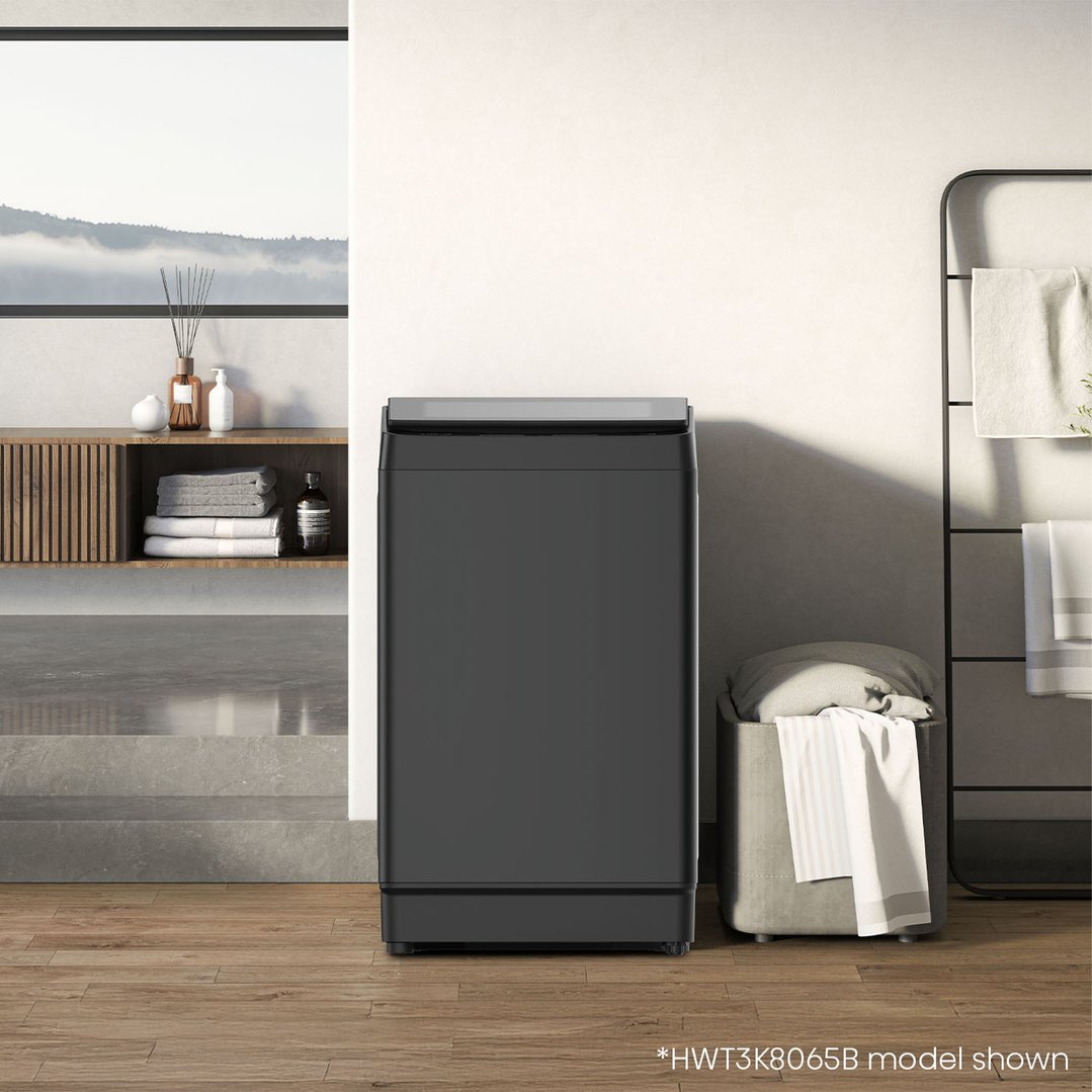 Black top load washing machine in a modern bathroom setting