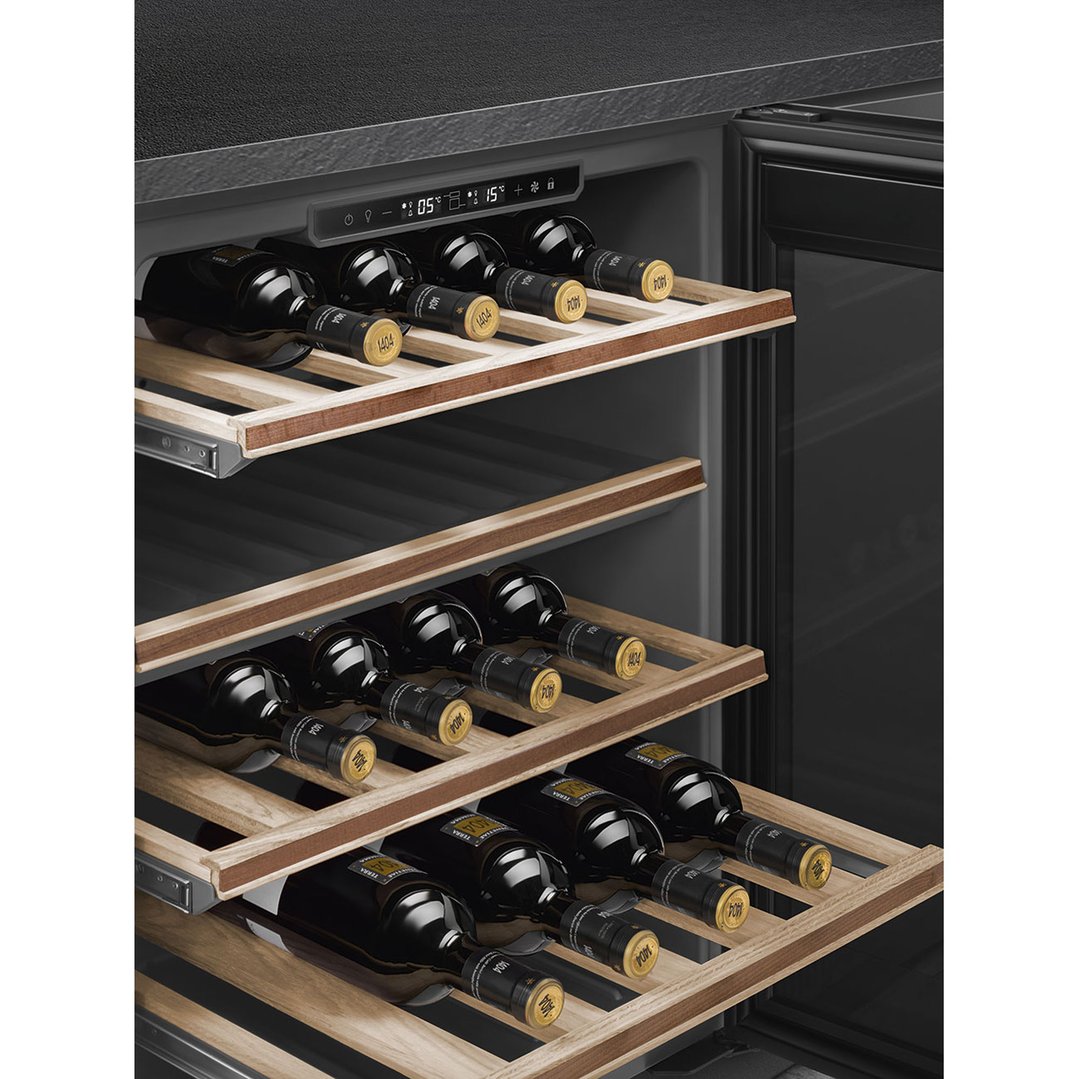 Close up of a built-in wine cooler with bottles on wooden shelves