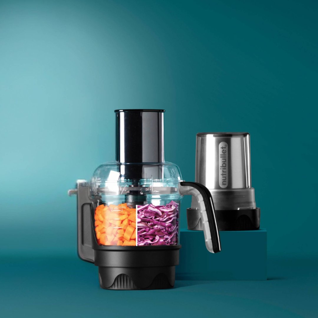 NUTRiBULLET Ultra Prep Accessory Kit with carrots and cabbage on a teal background