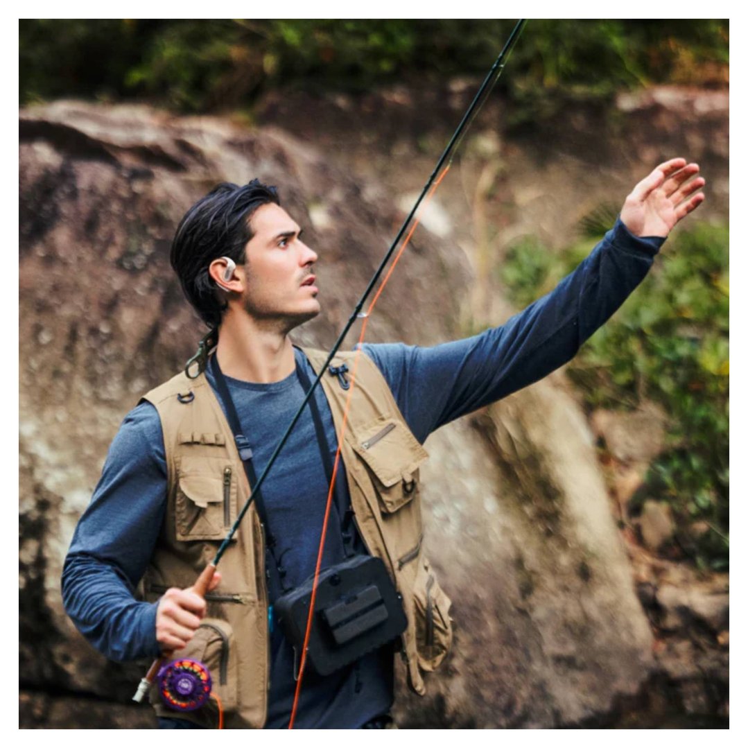 Man wearing OpenFit Pro Wireless Open-Ear Wireless Headphones while fishing