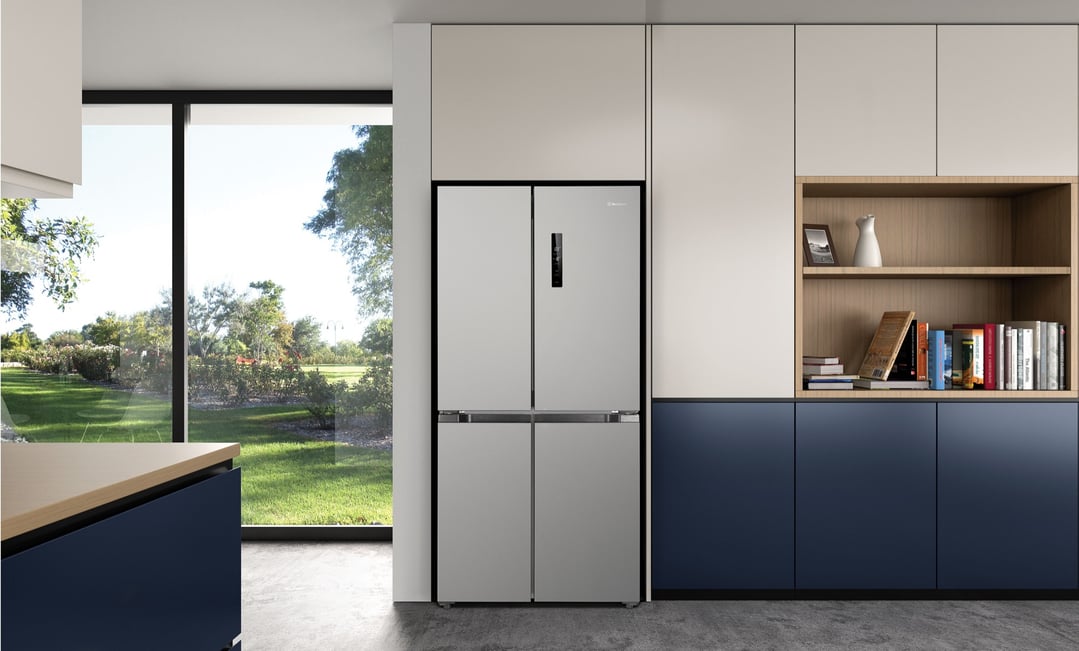 Silver French door fridge in a modern kitchen with a large window view