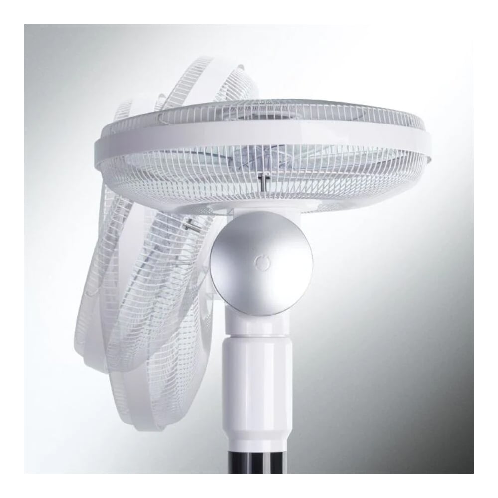 White pedestal fan oscillating, showing movement against a neutral background