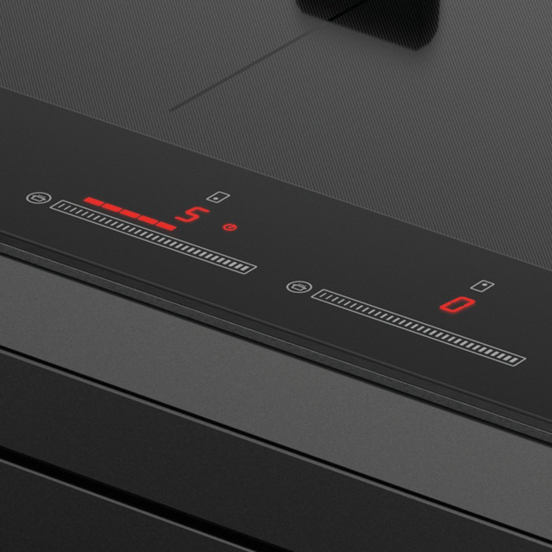 Close-up of a cooktop control panel with red digital display showing '5' and '0'