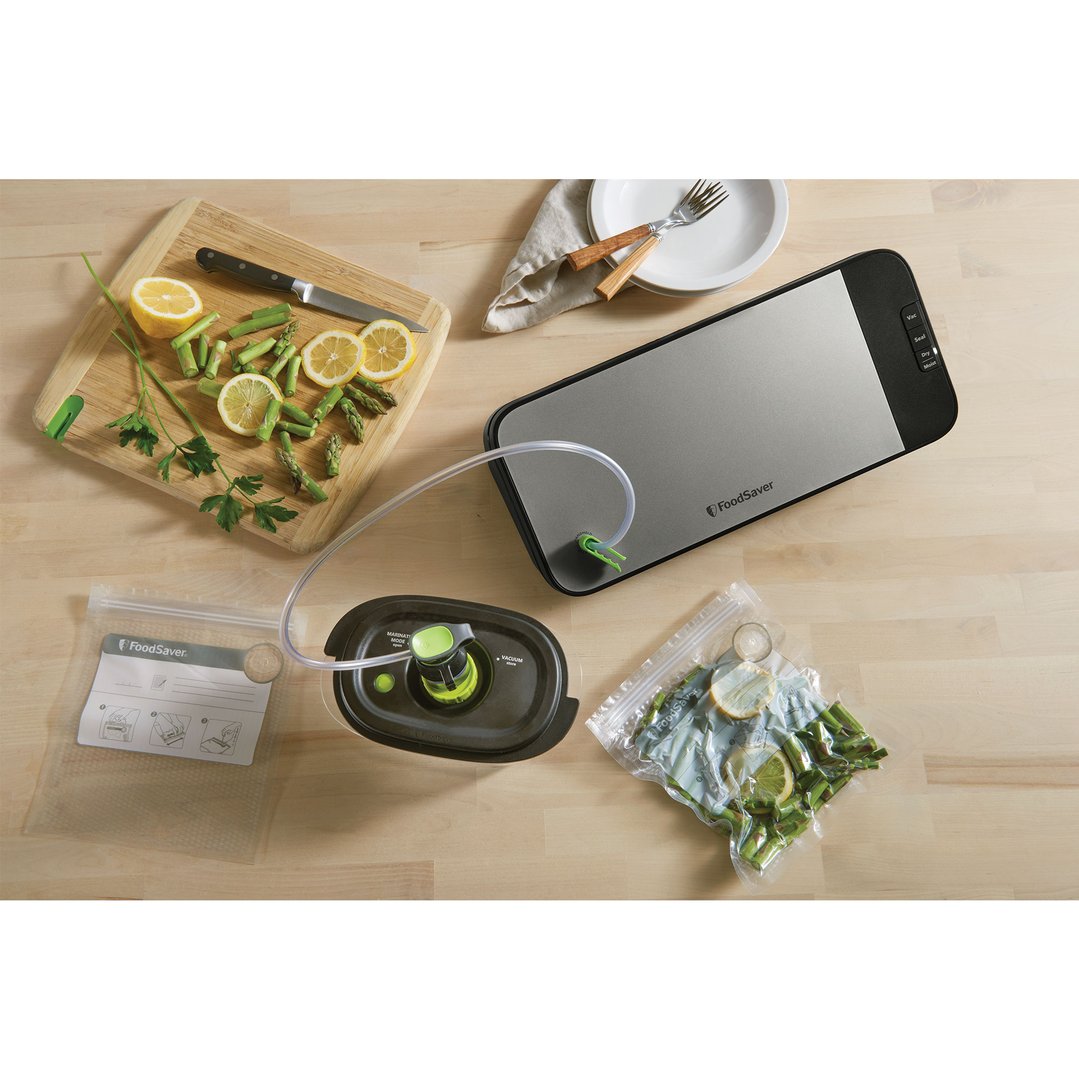 FoodSaver Cut & Seal Vacuum Sealer with accessories on a wooden countertop
