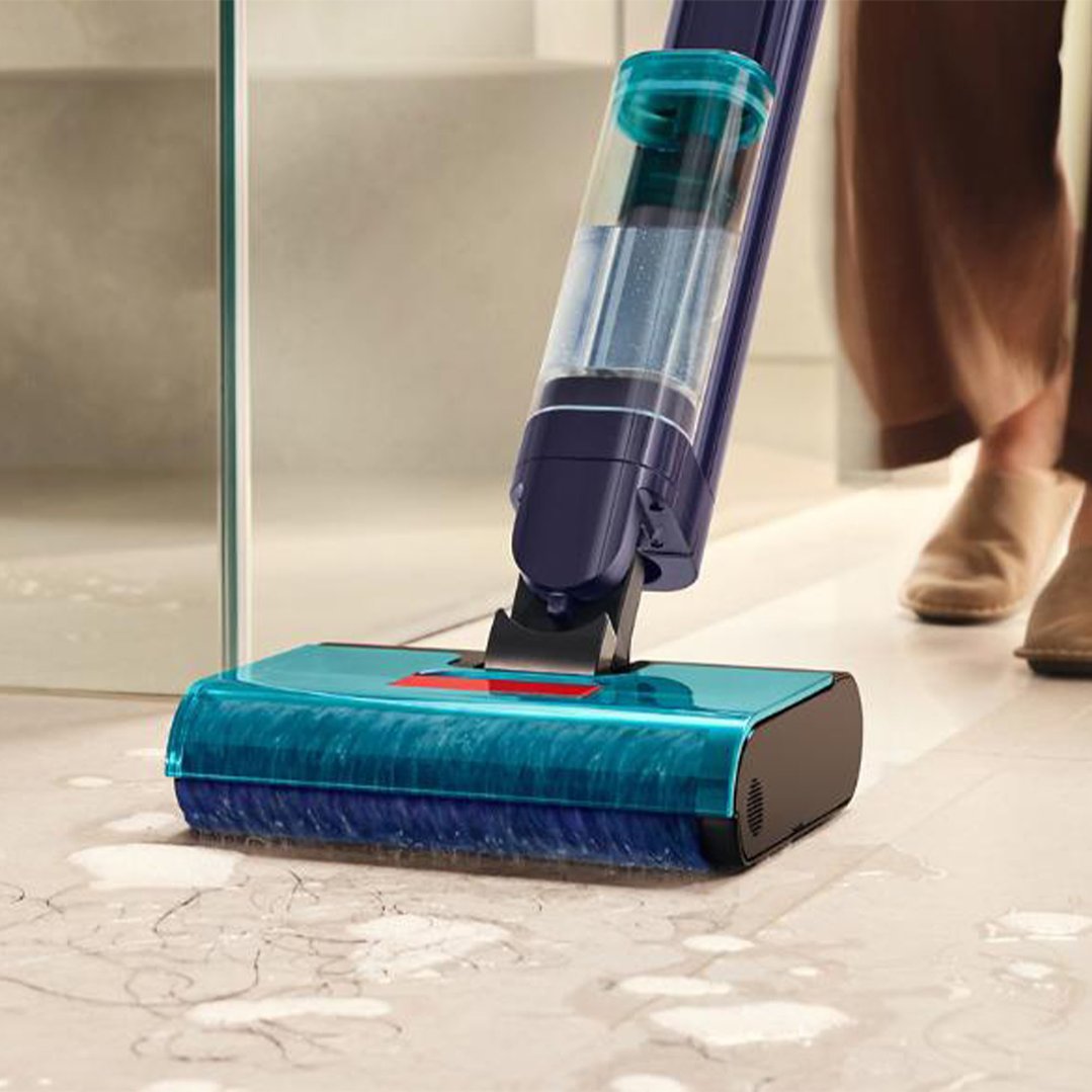 Dyson Clean+Wash Hygiene Hard Floor Cleaner cleaning a messy floor with water and debris