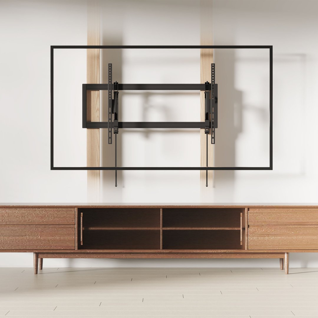 TV wall mount installed on a white wall above a wooden cabinet