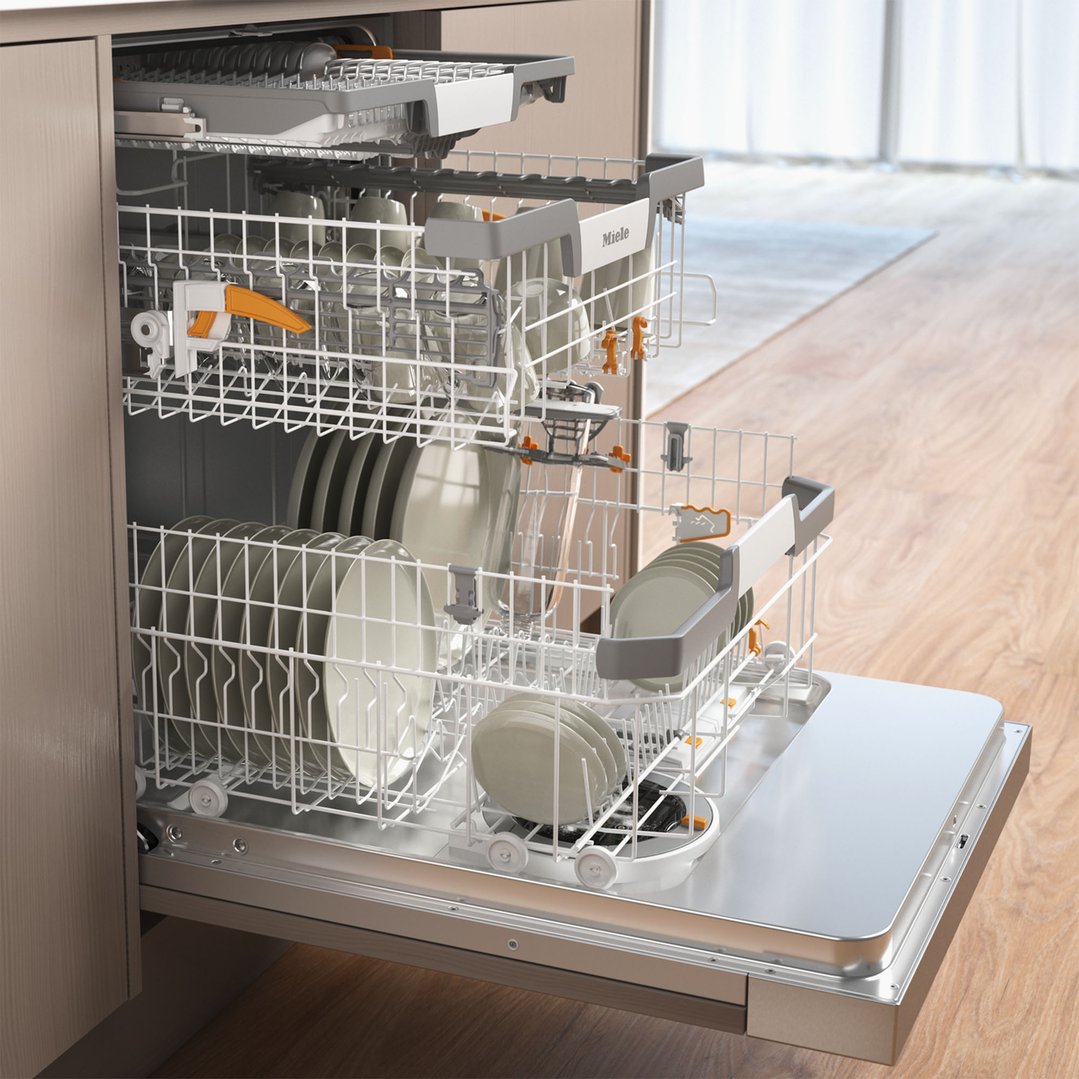 Open dishwasher with racks full of dishes in a kitchen setting