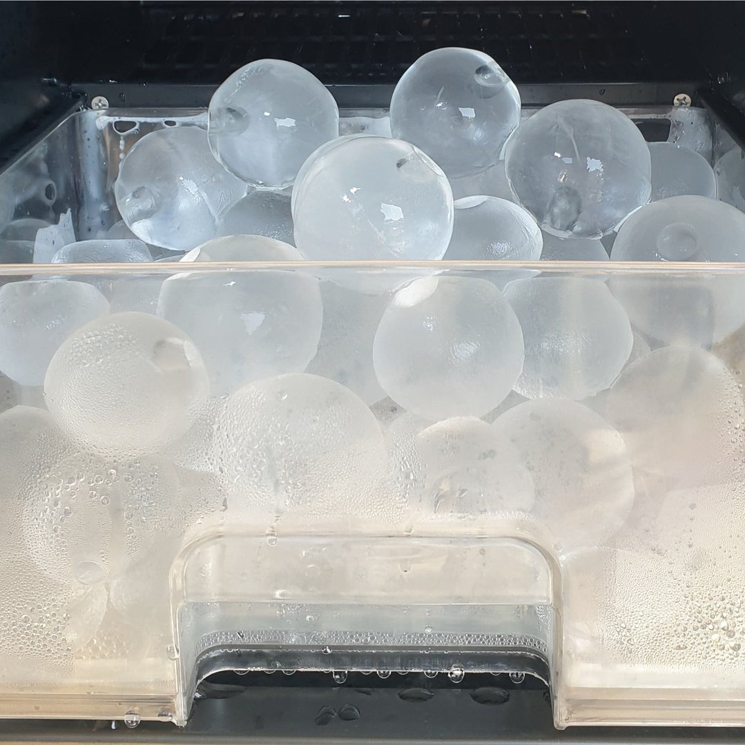 Close up of sphere ice maker filled with ice spheres