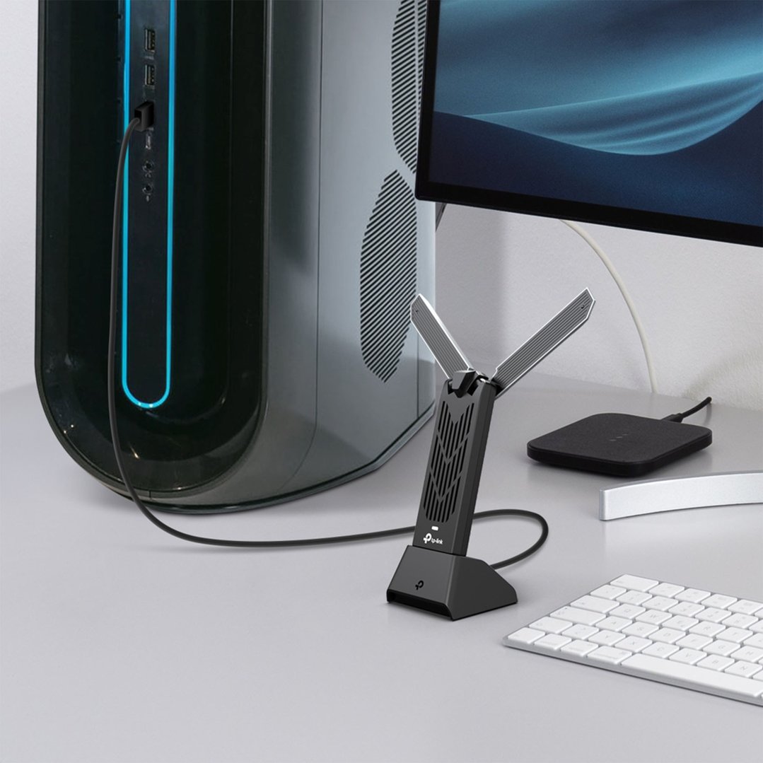 TP-LINK BE6500 Wi-Fi 7 High Gain Wireless USB Adapter connected to a desktop computer