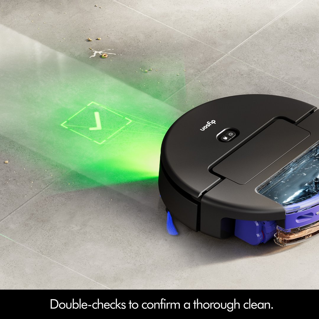 Dyson robot vacuum cleaner on a tiled floor, projecting a green checkmark