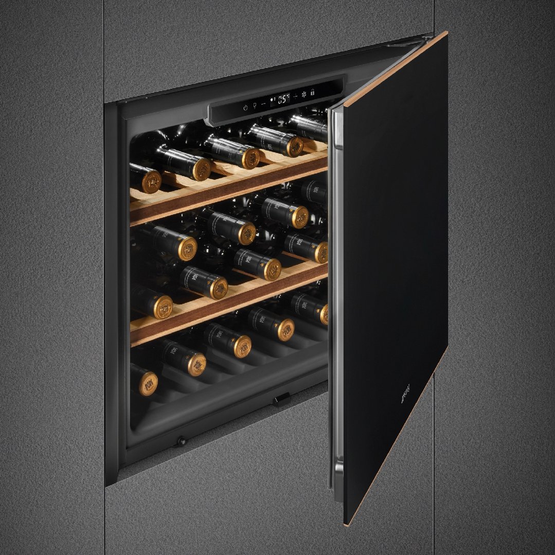 Built-in wine cooler with an open door showing multiple bottles of wine