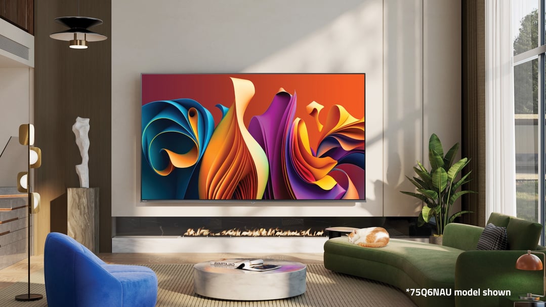 Hisense QLED Smart TV in a modern living room with a fireplace and green sofa