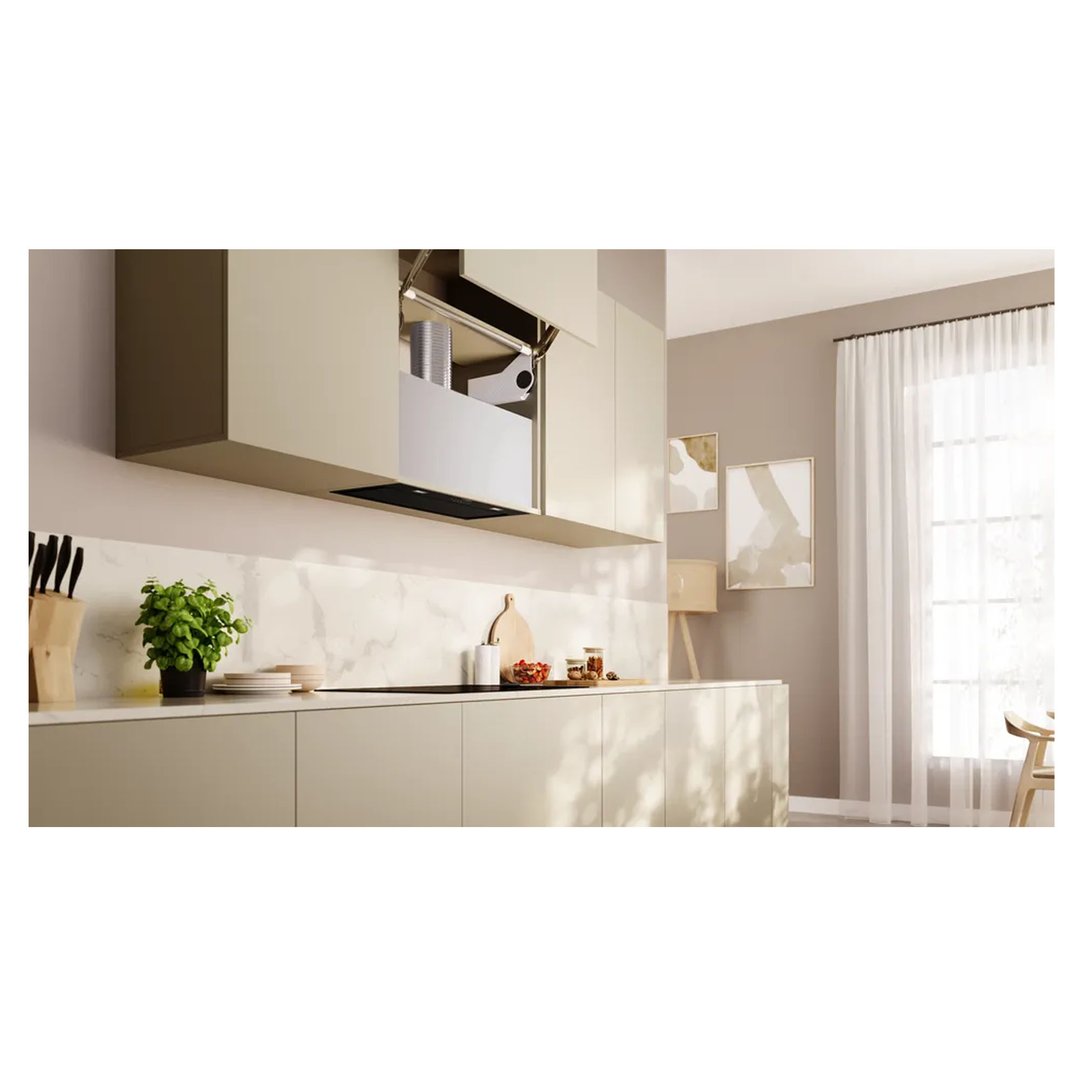 Integrated rangehood in a modern kitchen with light cabinetry and marble backsplash