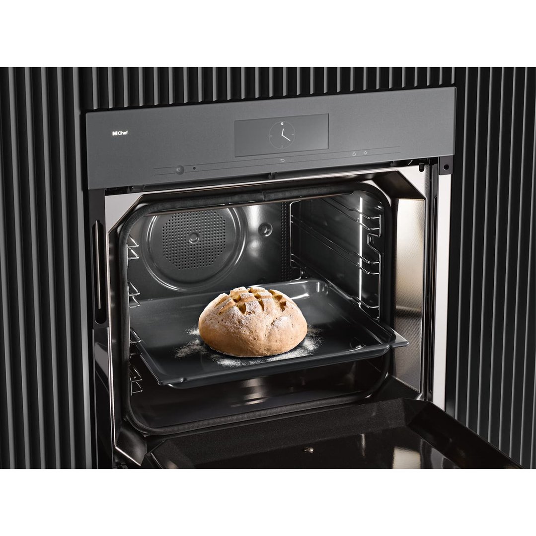 A Miele Dialog Oven with a loaf of bread on a tray inside