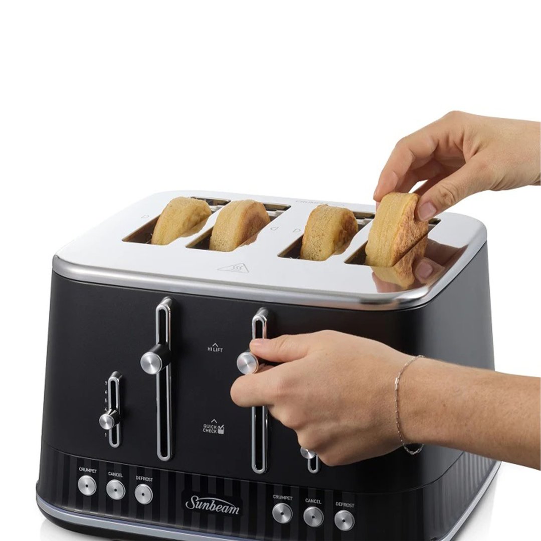 Hands placing bread into a black Sunbeam 4-slice toaster