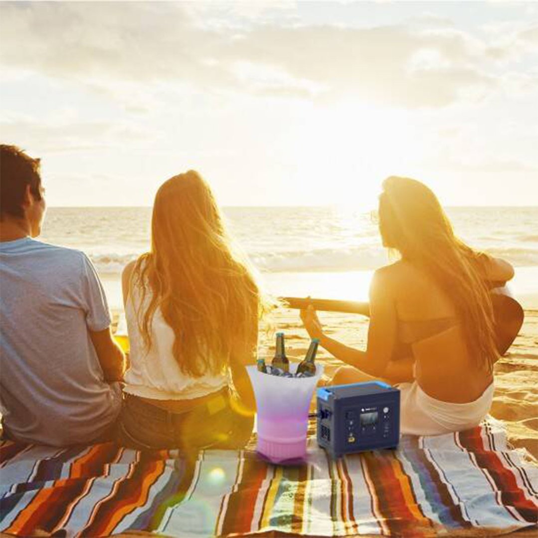 Portable power station on a striped blanket at the beach with people