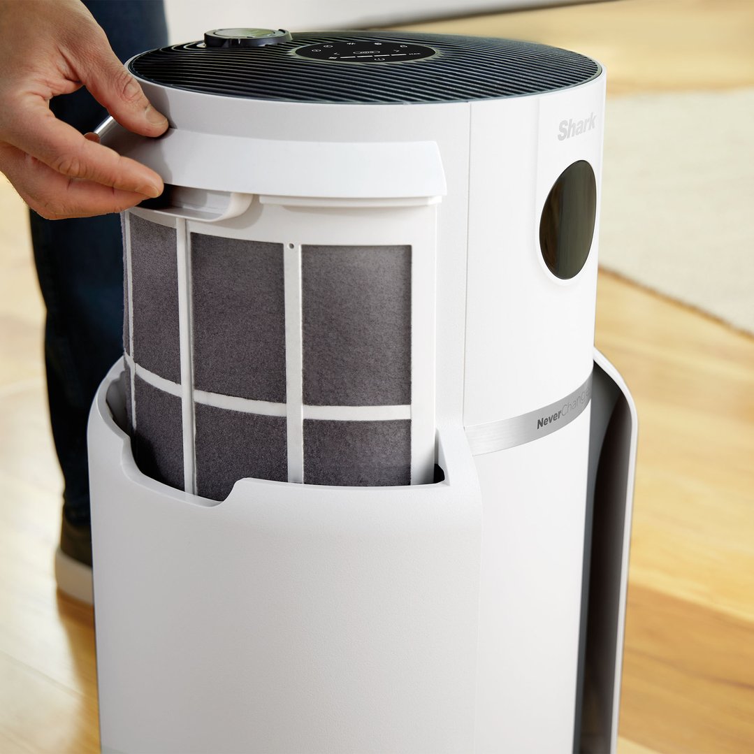 Hand opening the Shark air purifier to reveal the filter inside