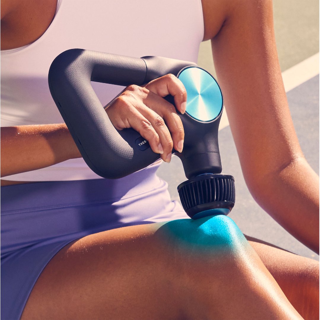 Person using a Theragun Cold Plus Attachment on their knee outdoors