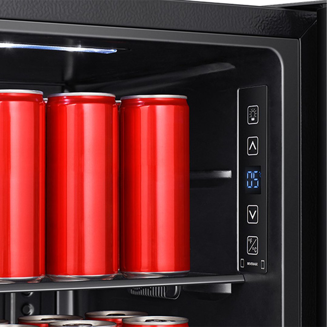 Close-up of a beverage cooler interior with red cans and digital controls