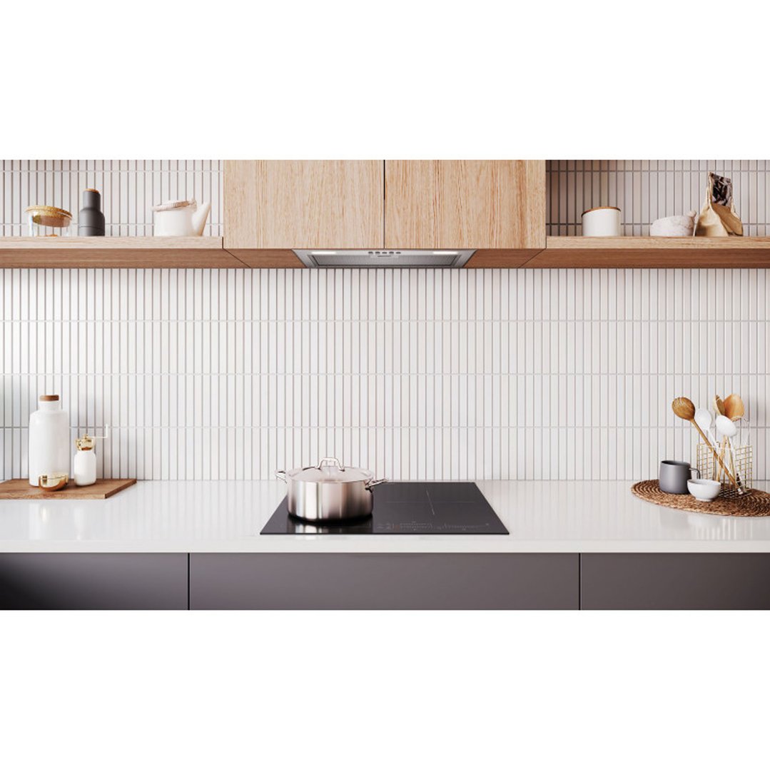 Integrated rangehood in a modern kitchen with a cooktop and pot