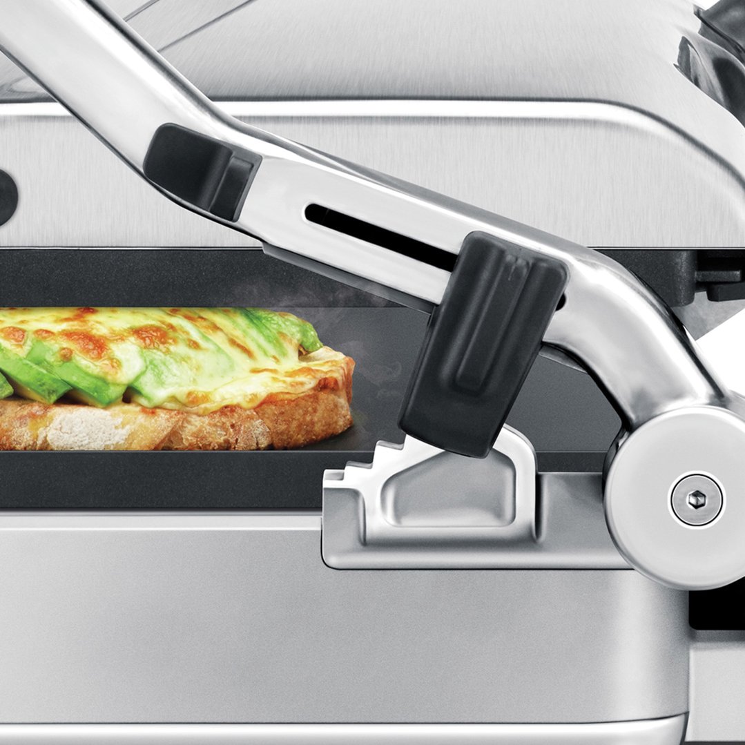 Close up of a sandwich with avocado and cheese on a grill