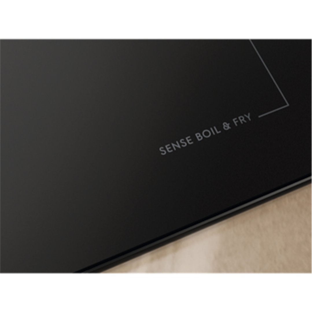 Close up of a black induction cooktop with "SENSE BOIL & FRY" text