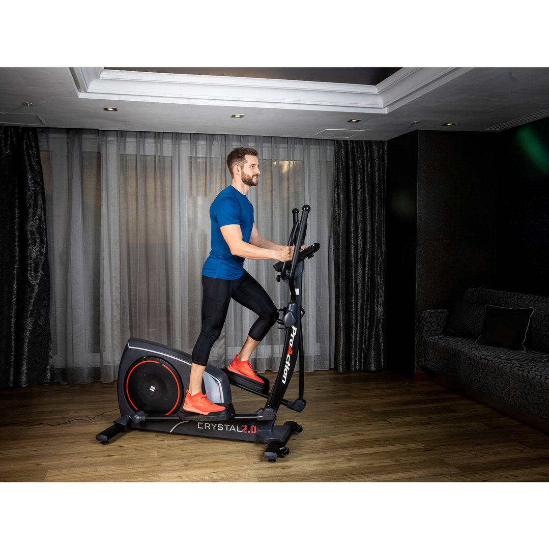 Man exercising on an elliptical in a modern living room setting