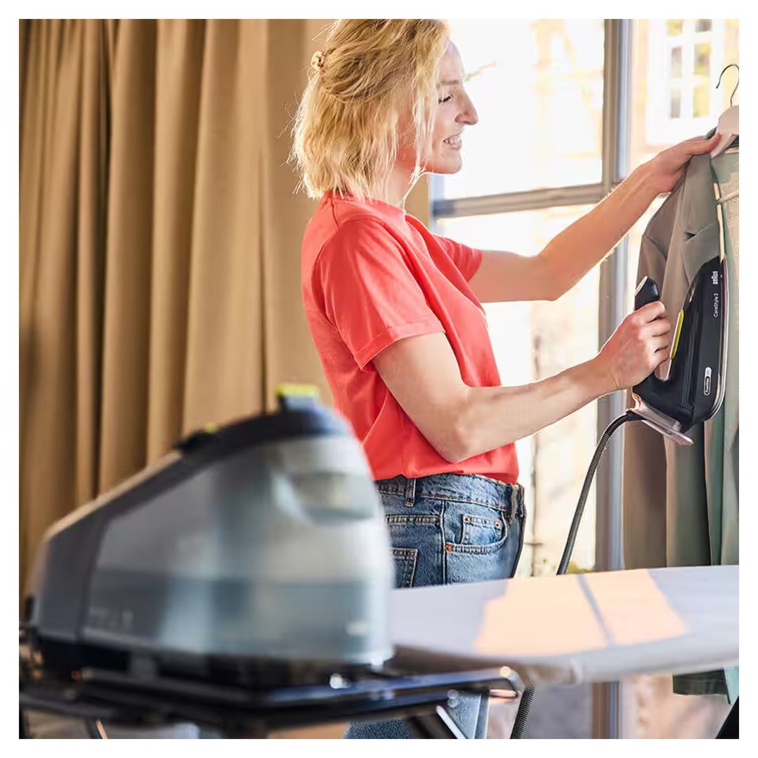 Woman using a Braun CareStyle 3 Steam Generator Iron to steam clothes