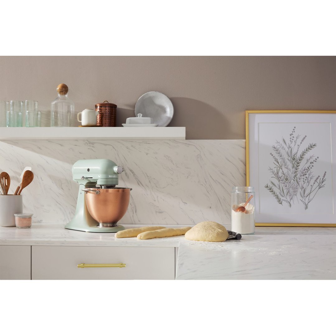 KitchenAid stand mixer with copper bowl on a kitchen counter with baking ingredients