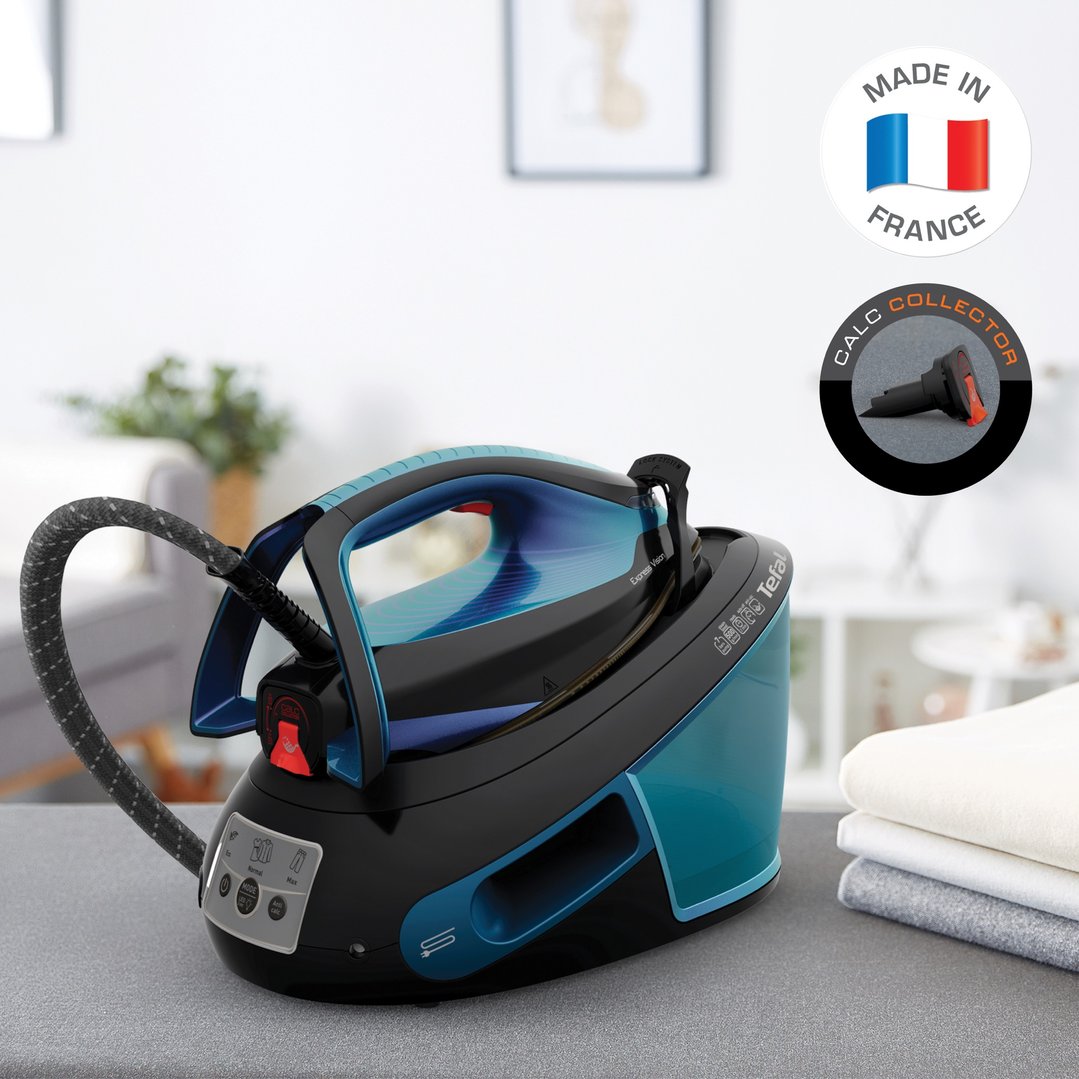 Tefal Express Vision Steam Station on a grey surface with folded clothes