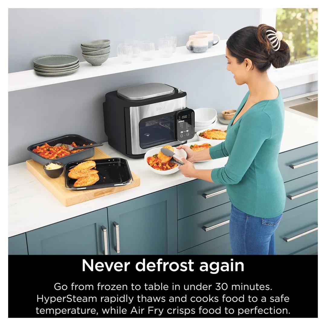 Woman serving food from a Ninja Combi 14-in-1 Multicooker in a kitchen
