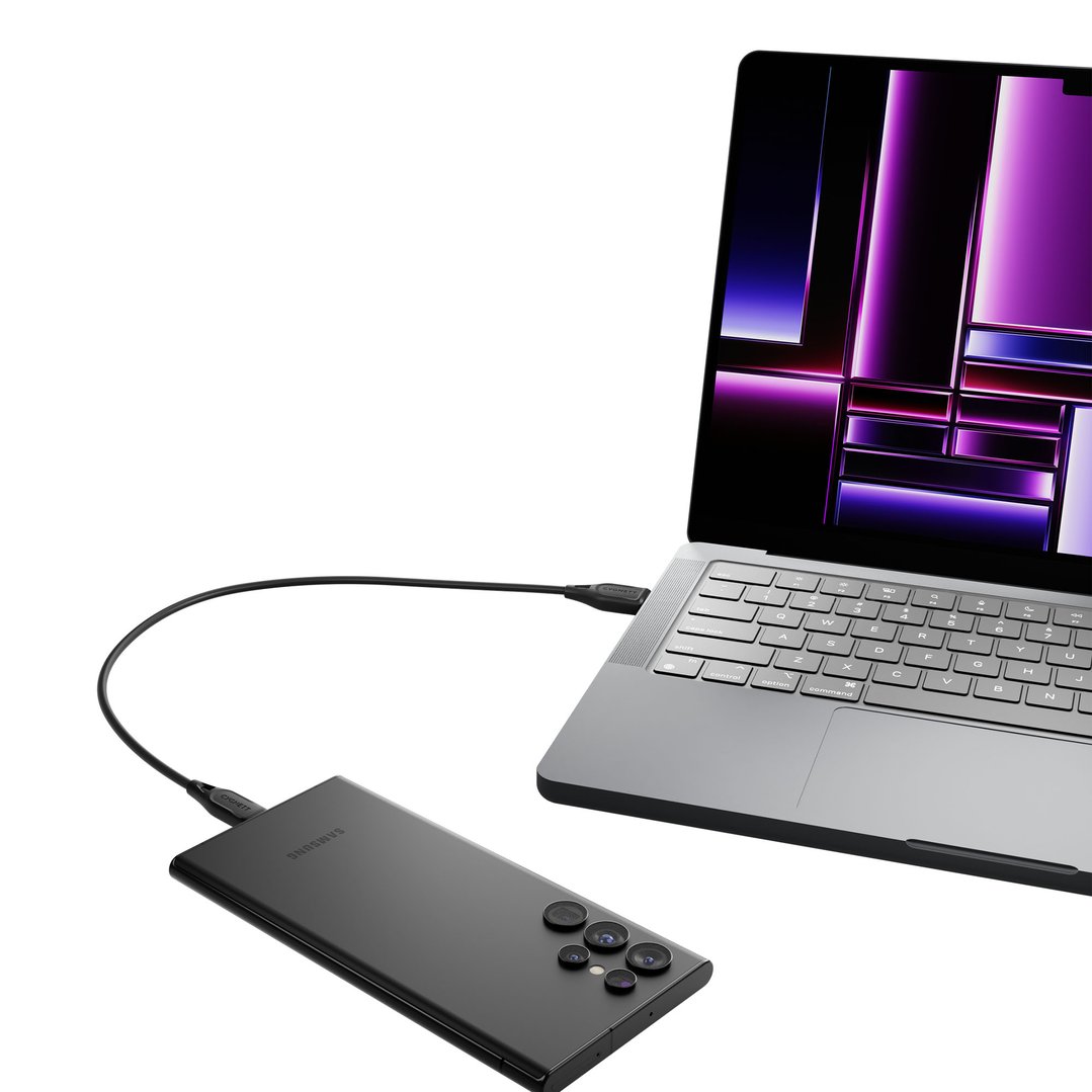 Black USB-C to USB-A cable connecting a laptop and a smartphone