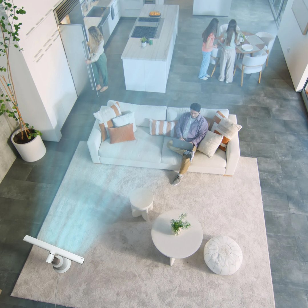 A TurboBlade Fan illuminating a living room with people in a modern home