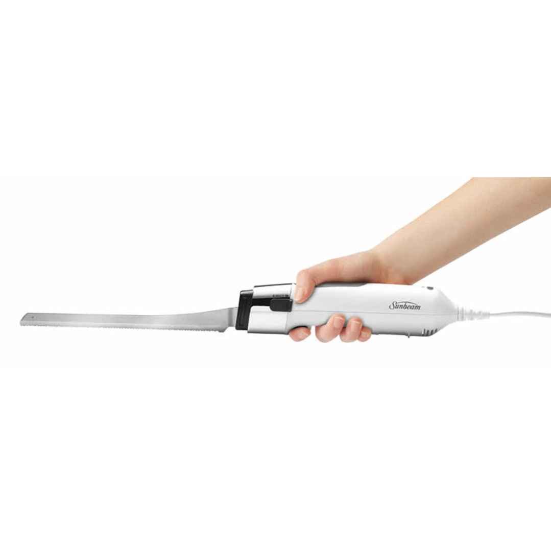 Hand holding a white Sunbeam electric carving knife with a long blade
