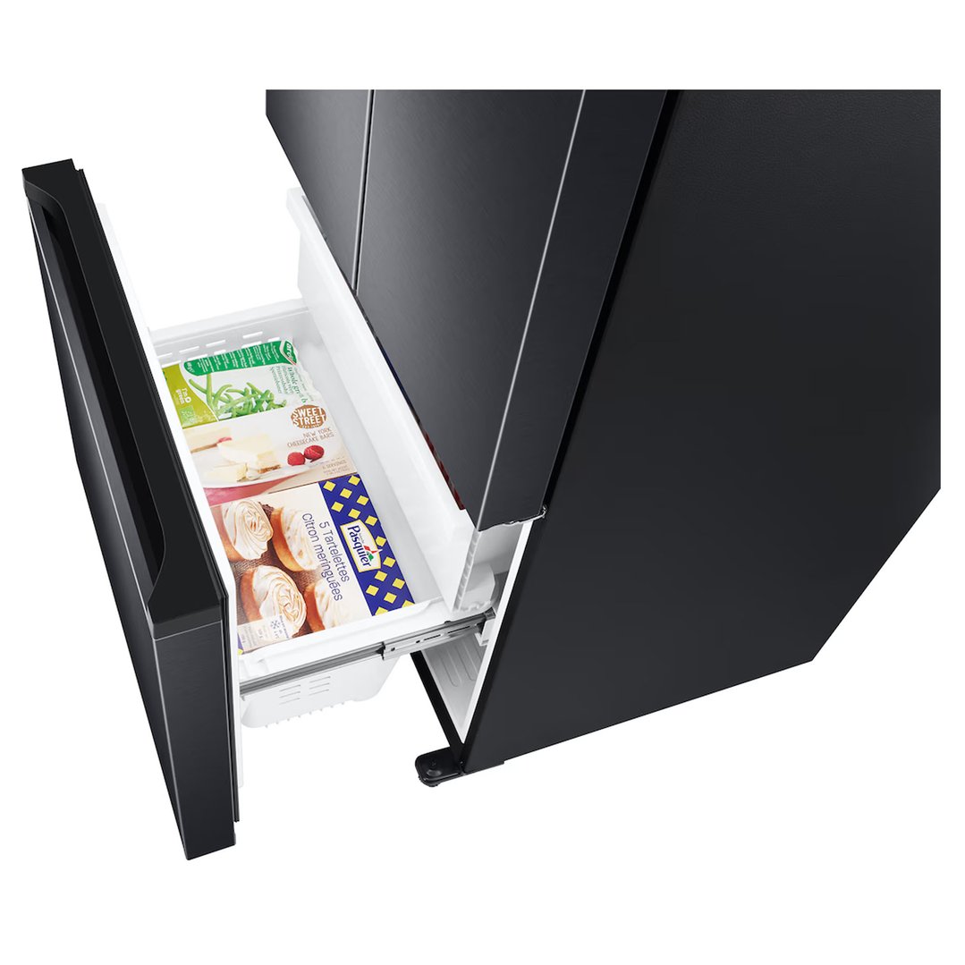 Open freezer drawer of a black French door refrigerator with food items inside