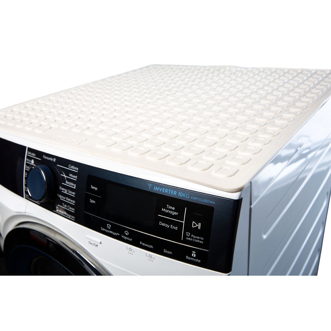 White appliance mat on top of a washing machine with control panel visible