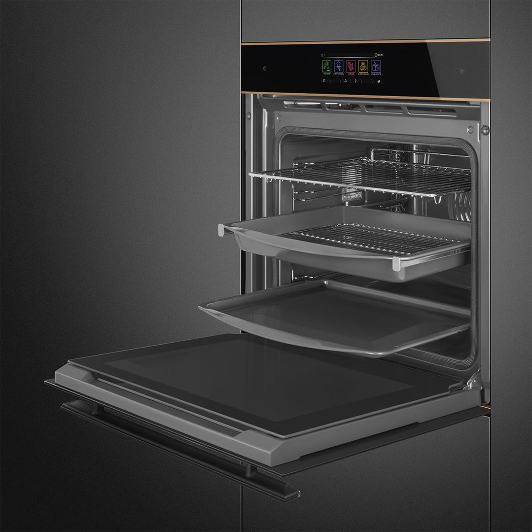 Open black glass and copper trim oven with racks and trays pulled out