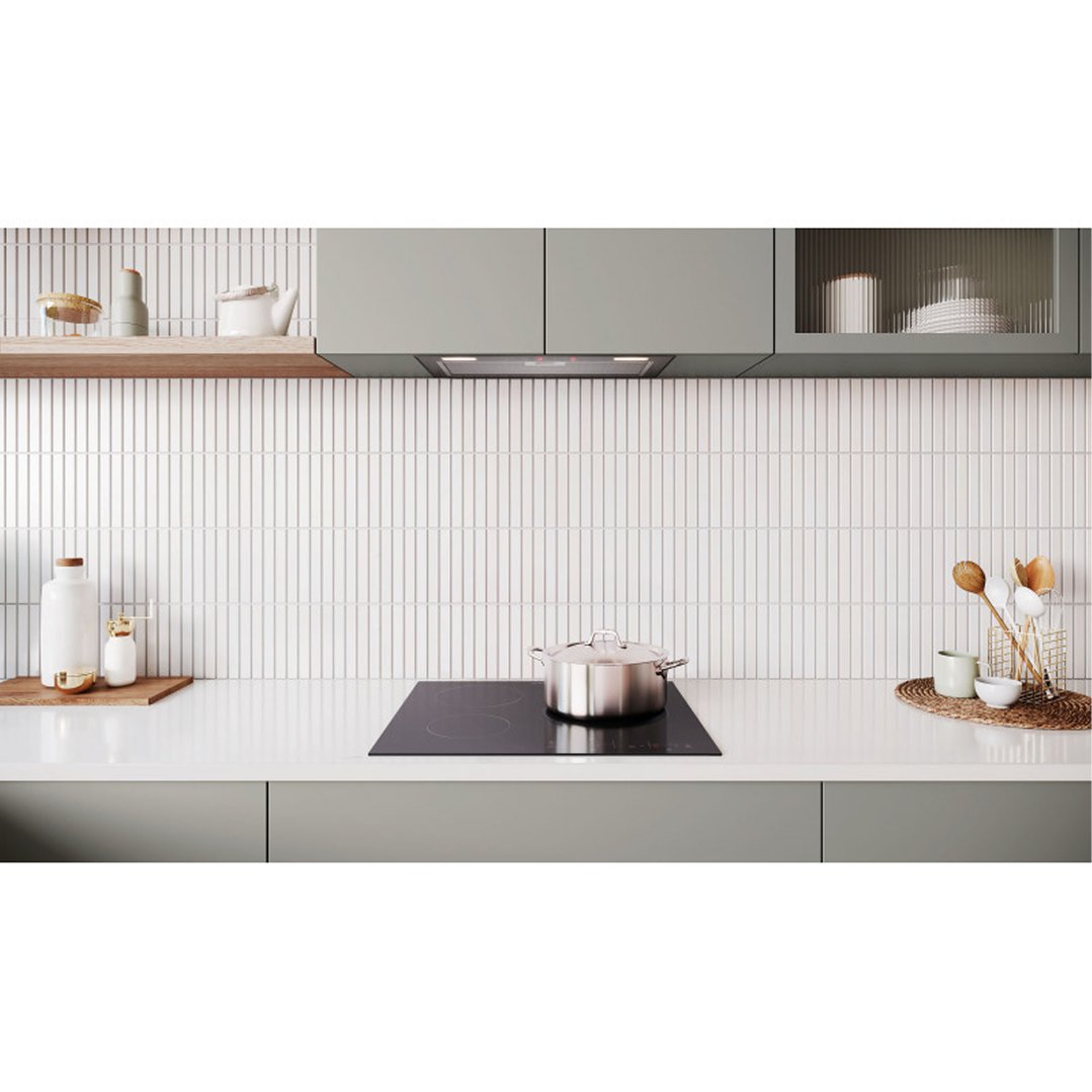 Integrated rangehood in a modern kitchen with a pot on an induction cooktop